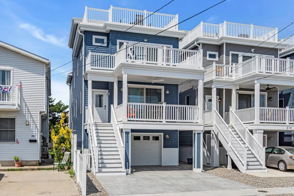 Multi-balcony blue shore house exterior at a Breezy Beach Stays property in Seaside Heights