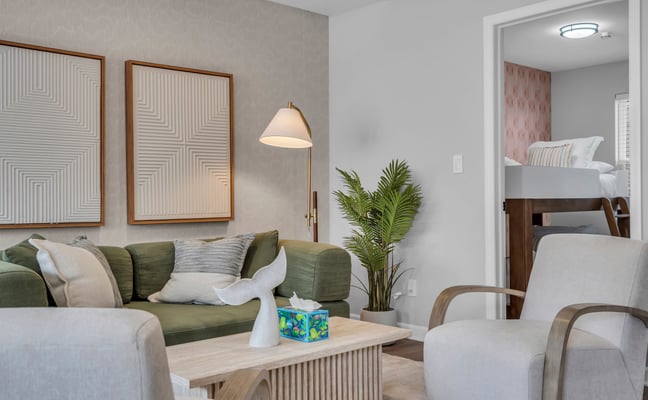Cozy Shore rental living room with green sofa, coastal decor, and warm lighting