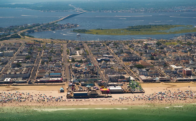 Aerial view of Seaside Heights boardwalk, beach, and town from above on a summer day