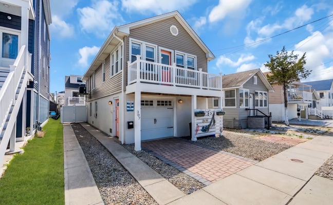 Two-story Shore home with white siding and a front porch